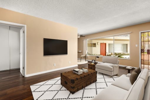 a living room with a white couch and a television