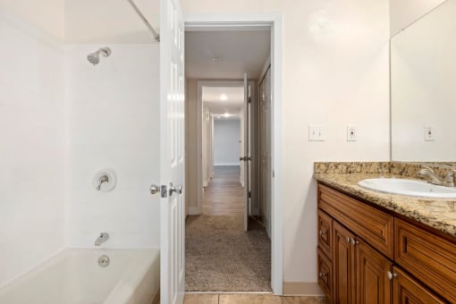 Studio Apartments in Encino CA - White Oak Terrace - Full Bathroom with Tub, Shower, and Wood-Style Cabinetry
