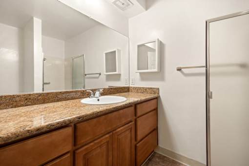 a bathroom with a sink and a shower at White Oak Terrace Apartments, Encino, CA