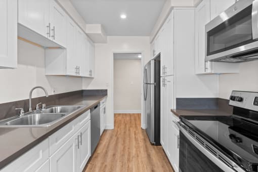 Apartments for Rent in Encino CA - White Oak Terrace - White Kitchen with Stainless Steel Appliances and Silver Hardware