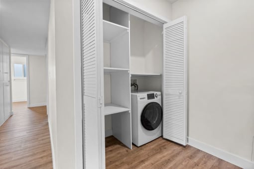 a laundry room with a washing machine in it