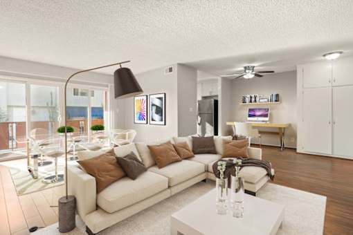 A modern living room with a white sofa and a glass table.