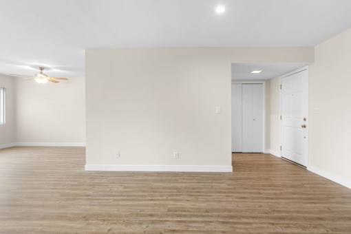 A room with wooden floors and white walls.