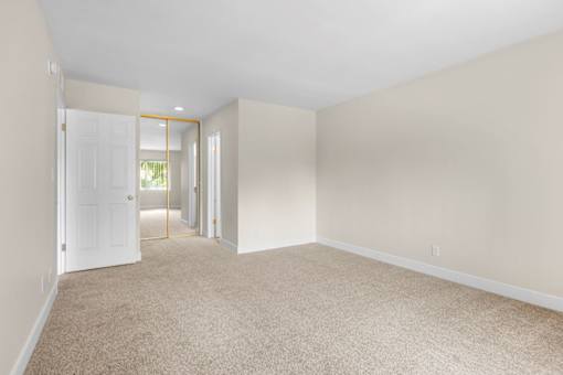 A room with a carpeted floor and white walls.