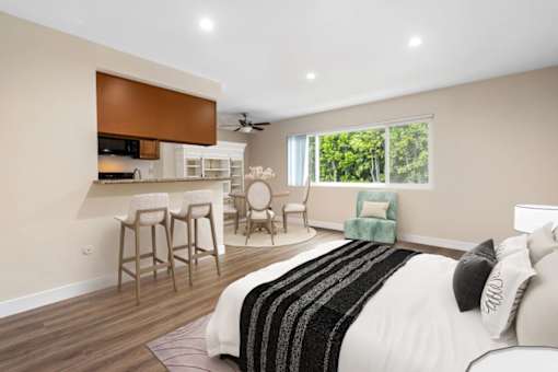 a bedroom with a bed and a living room with a kitchen at Lombardi Apartments, Woodland Hills