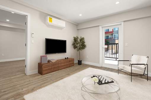 a living room with a tv and a table at Woodland Trio Apartments, North Hollywood, California