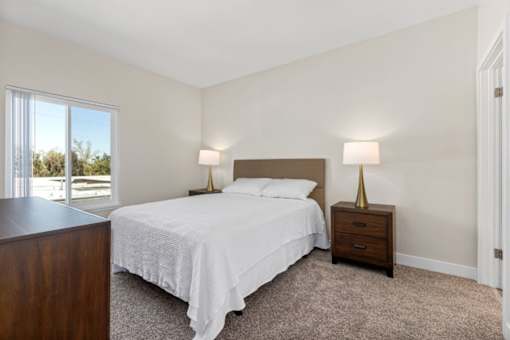 a bedroom with a bed and a window at Woodland Trio Apartments, California