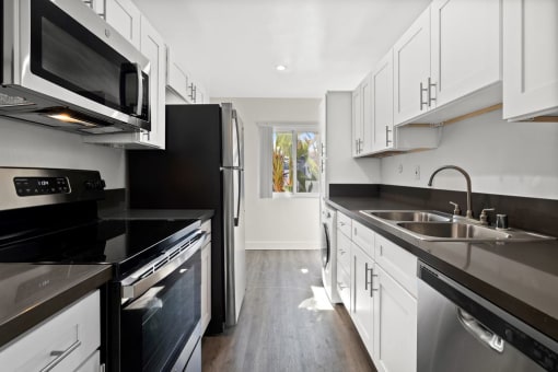 stainless steel appliances, and modern wood cabinets at The Reserve at Warner Center, Woodland Hills, CA, 91367