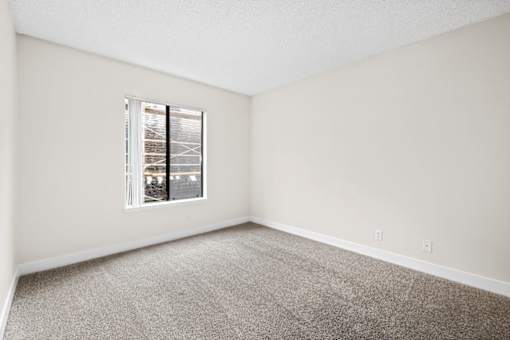a bedroom with a large window at Woodland Trio Apartments, North Hollywood, California