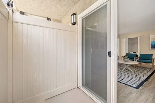 an open door leading to a living room with a couch and coffee table in the background at Casa De Marina Apartments, Los Angeles, CA 90066
