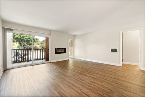 an empty living room with wood floors and a fireplace at Parkway Terrace Apartments, Culver City, CA, 90230