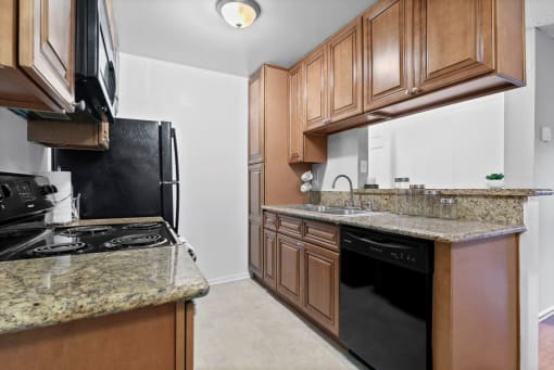 Mar Vista CA Apartments -Furnished Kitchen with Convenient Amenities Like Fridge, Microwave, and Stove and Upgraded Cabinets and Granite Countertops