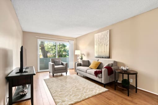 Mar Vista Apartments for Rent - Vista - Jones & Jones - Spacious Living Room With Wood-Style Floors and Attached Patio
