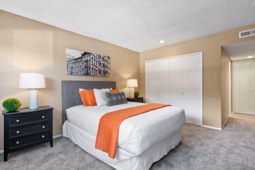 Encino Apartments - Spacious Bedroom with Plush Carpet, Neutral Colored Walls and Sliding Closet Doors.