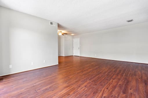Apartments for Rent in Sherman Oaks, CA - Kystral Terrace - Living Room with Open Layout, Wood-Style Floors, and White Walls