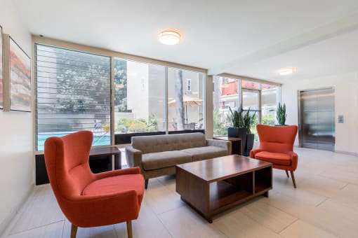 Sherman Oaks Apartments - Krystal Terrace Apartments Lobby with Table, Cozy Seating, and Modern Decor
