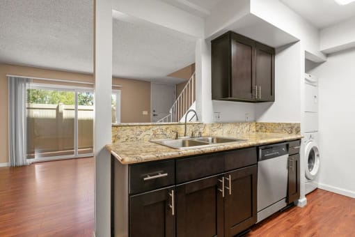 Kitchen with Granite Countertops, New Espresso Cabinetry, Wood Flooring and Stainless Steel Appliances at The Meadows at Westlake Village Apartments, Westlake Village, CA
