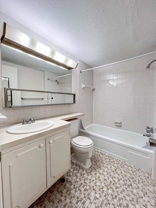 an empty bathroom with a sink toilet and bath tub