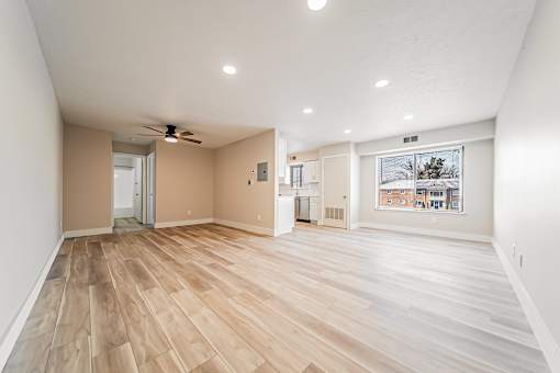 A room with wooden flooring and a ceiling fan.