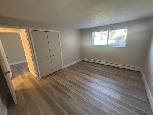 A room with a wooden floor and a window.
