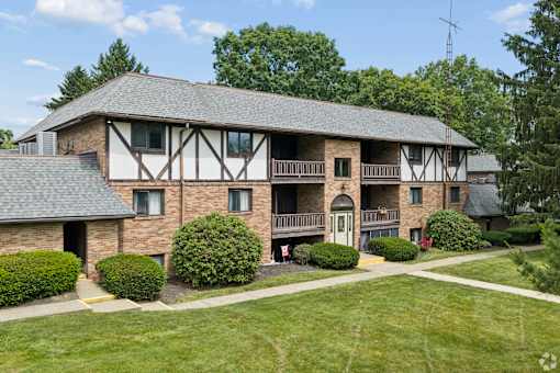 A large house with a balcony and a covered patio.
