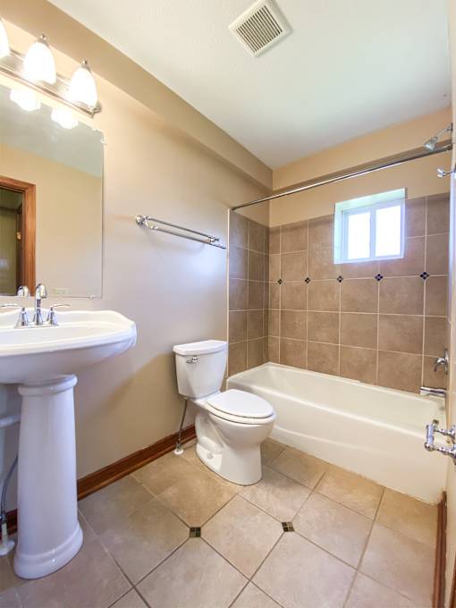 a bathroom with a toilet and a sink and a bath tub