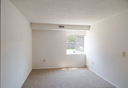 A room with a window and carpeted floor at Hummingbird Pointe & The Gardens, Parma, 44129