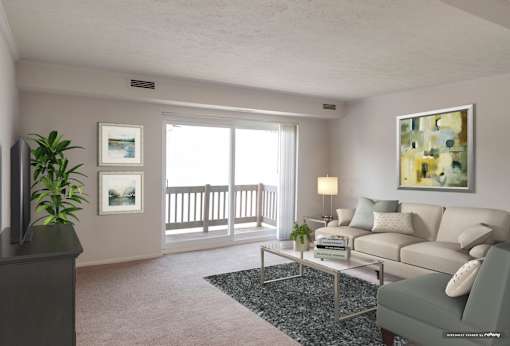 A living room with a grey couch, a coffee table, and a painting on the wall at Hummingbird Pointe & The Gardens, Ohio 44129