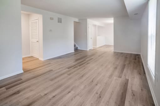 a bedroom with hardwood floors and white walls