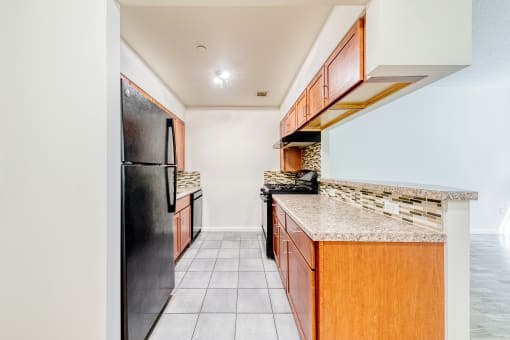 Kitchen with granite countertops and black appliances