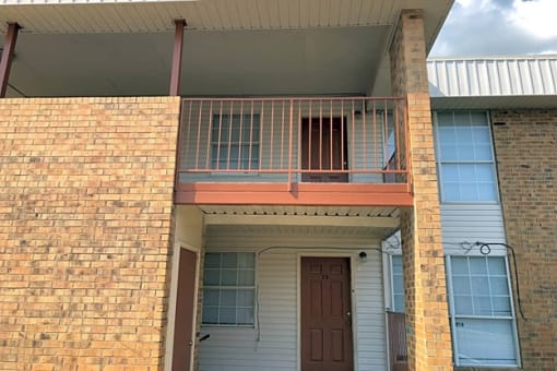 a house with a balcony on the side of a building