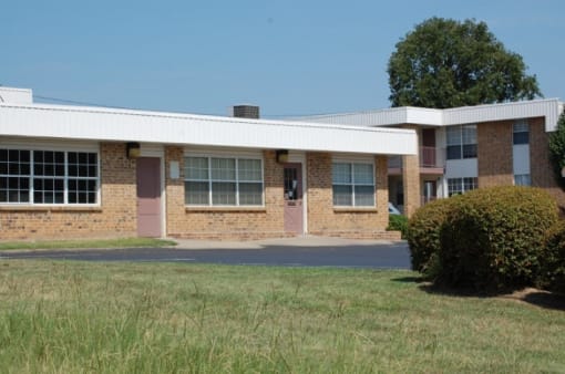 a building with a grassy yard in front of it