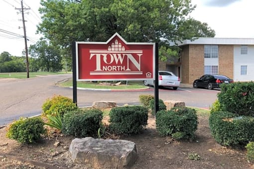 a town north sign in front of a building
