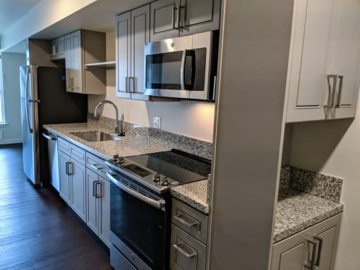 Kitchen with Black Appliances at AJ, Washington, 98116