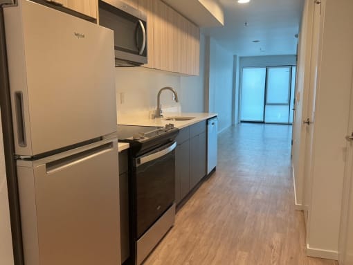 a kitchen with a stove and a refrigerator and a sink at Junction Central, Washington, 98116