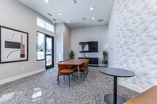 A modern dining room with a wooden table and chairs.