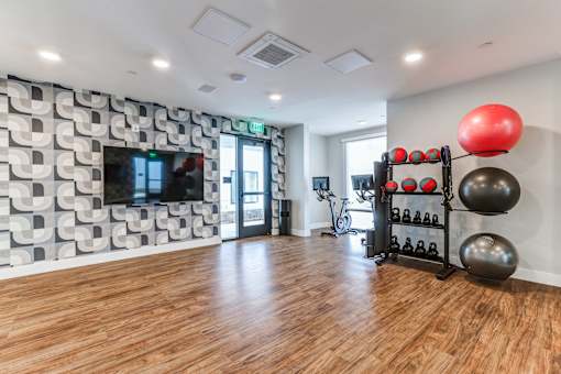 A room with wooden floors and a patterned wallpaper.