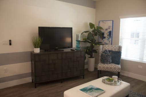 a living room with a tv and a chair at The Crossings at Redlands, Redlands, CA, 92374