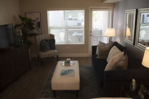 a living room with a couch and two chairs at The Crossings at Redlands, California