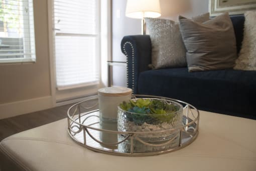 a coffee table with a tray and a candle on it at The Crossings at Redlands, Redlands, CA