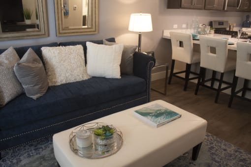 a living room filled with furniture and a large window  at The Crossings at Redlands, Redlands, CA