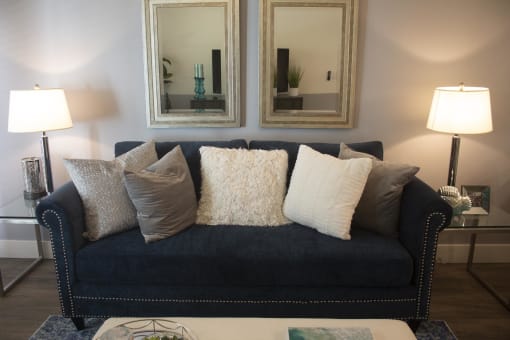 a couch with pillows in a living room at The Crossings at Redlands, Redlands, CA, 92374