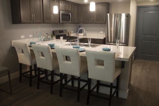 a kitchen with a large island and a stainless steel refrigerator  The Crossings at Redlands, Redlands, 92374