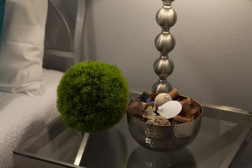 a side table with a bowl of driftwood and a sphere at The Crossings at Redlands, California