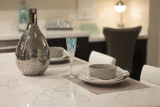 a table with a vase and plates on it at The Crossings at Redlands, Redlands, California