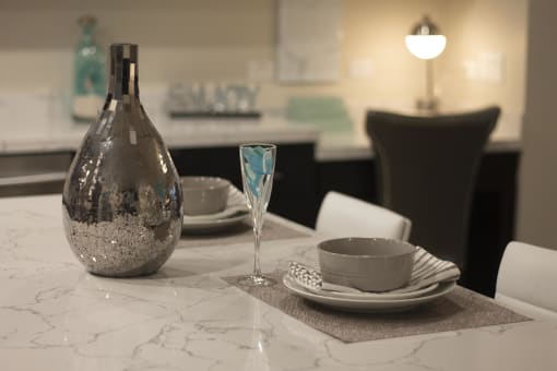 a table with a vase and a cup on it at The Crossings at Redlands, Redlands, CA, 92374