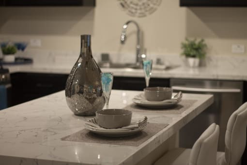 a kitchen with a sink and a table at The Crossings at Redlands, Redlands, CA