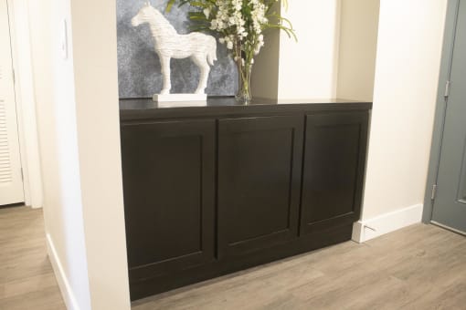 a large black cabinet with a white horse on top of it at The Crossings at Redlands, Redlands, 92374