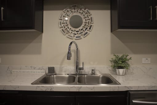 a kitchen sink with a mirror above it at The Crossings at Redlands, California 