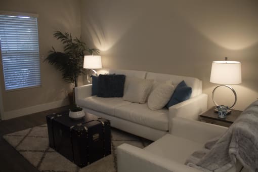a living room with a couch and two chairs at The Crossings at Redlands, California